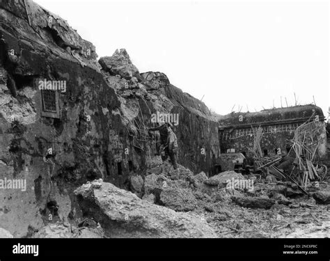 Two American soldiers examine the battered casement of Fort Driant, key ...