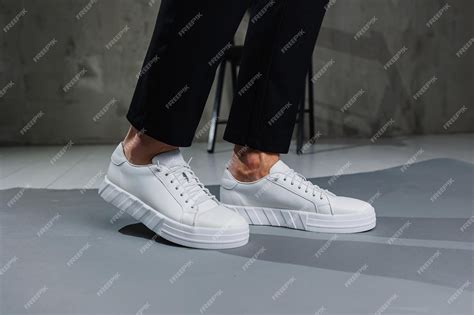 Premium Photo | Modern men's shoes Male legs in black pants and white ...