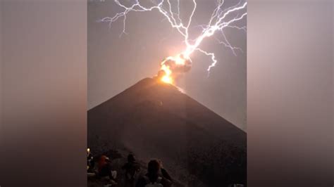 Lightning strikes erupting volcano.