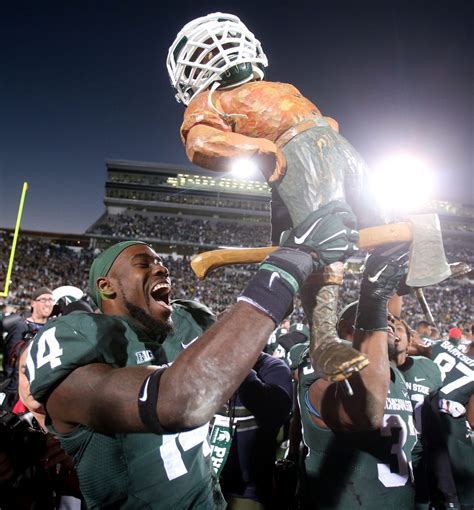 Best photos of Michigan vs. Michigan State winner raising Paul Bunyan