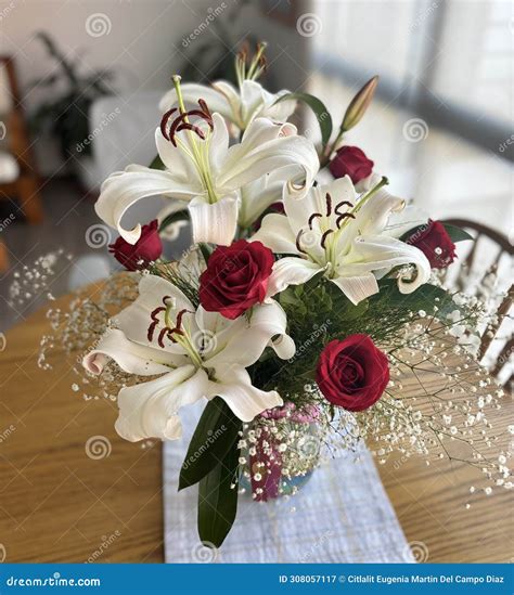 Flower Arrangement of Red Roses, Lily Flowers and Green Leaves Stock ...