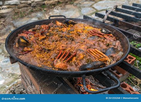 Spanish Paella Cooked on Natural Log Fire and Coal in a Traditional ...