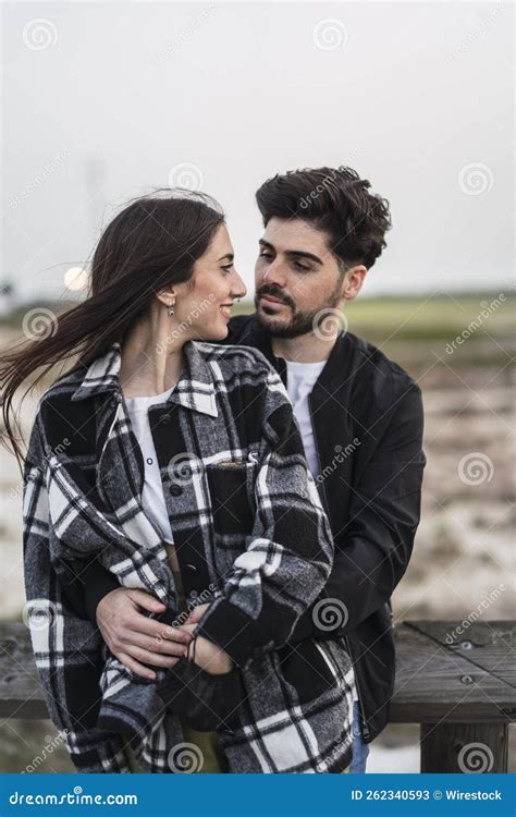Vertical Shot of a Cute Spanish Caucasian Couple Gazing at Each Other ...