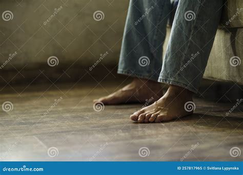 Close Up on a Male Bare Feet on the Hard Wood Floor while Sitting on ...