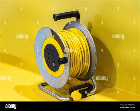 Electric cable cord winding reel yellow manual cable extension Stock ...