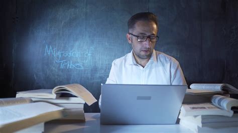 The historian man who writes Migration of Tribes on the blackboard. 32425878 Stock Video at Vecteezy