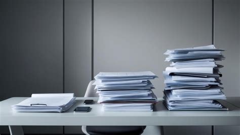 Stacks of documents and financial reports in modern office workspace ...