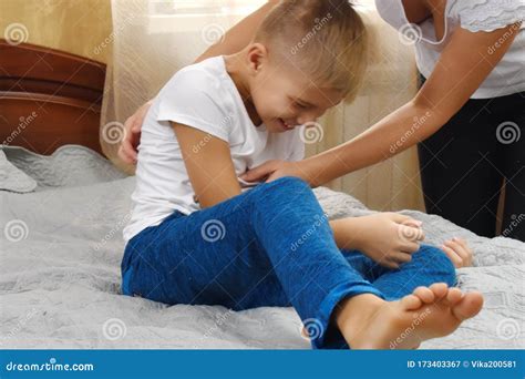 Tickle the Child. Happy Mother and Son on the Bed. Funny Motherhood ...