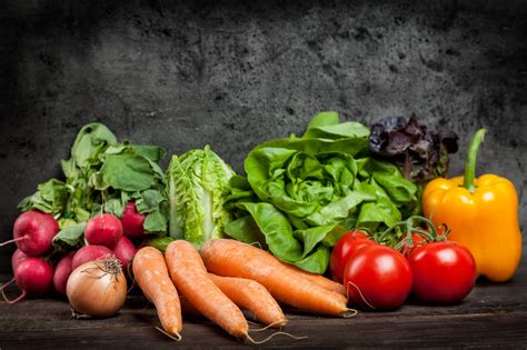 Fresh organic vegetables on rustic background – Snapshopy.com