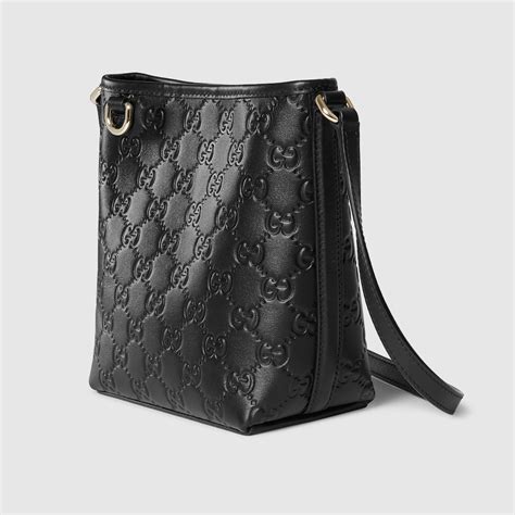 GG Emblem nano bucket bag in black GG leather | GUCCI® SG