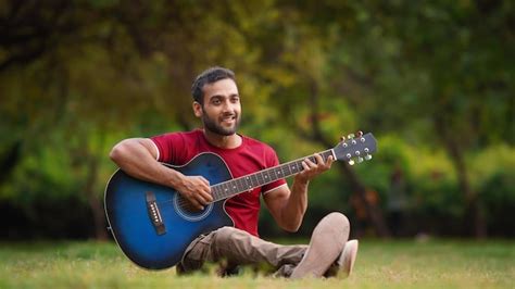 Man guitar playing in park indian boy | Premium Photo