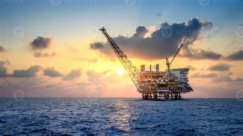 Offshore oil and rig platform in sunset or sunrise time. Construction ...