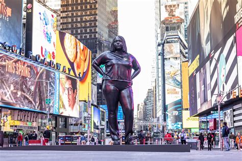 There's a massive bronze sculpture of a woman in the middle of Times ...