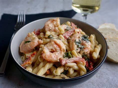 Creamy shrimp sauce with wine, sun dried tomatoes and spinach served ...