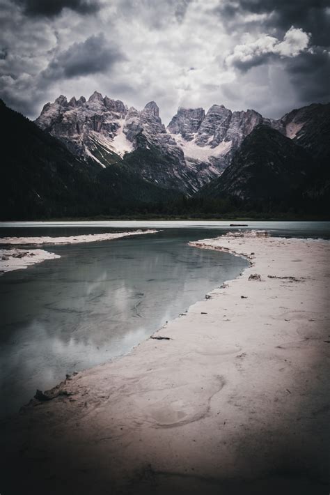 Download wallpaper 3517x5275 mountains, lake, clouds, shore hd background