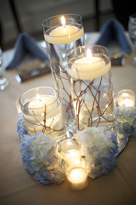 centerpieces...3 tiered glass hurricanes with twigs inside, floating ...