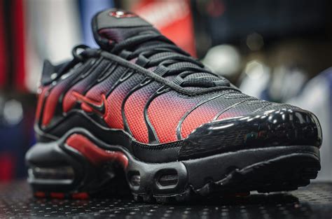 A pair of black and red sneakers on a table photo – Free Shoe Image on ...