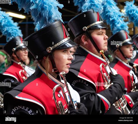 High school boys & girls holding trumpets ready to march in St. Patrick ...