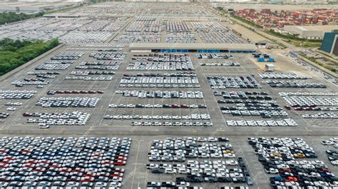 Premium Photo | Aerial view of new cars stock at factory parking lot ...