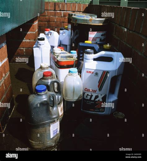 Oil recycling. Containers of oil for recycling at a waste disposal site ...