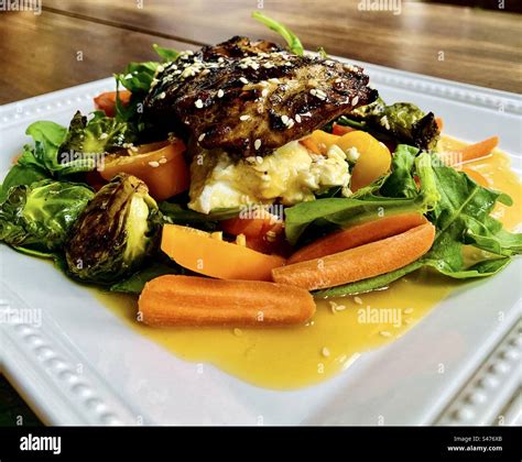 Marinated barbecued chicken thigh on a goat cheese, arugula, spinach ...