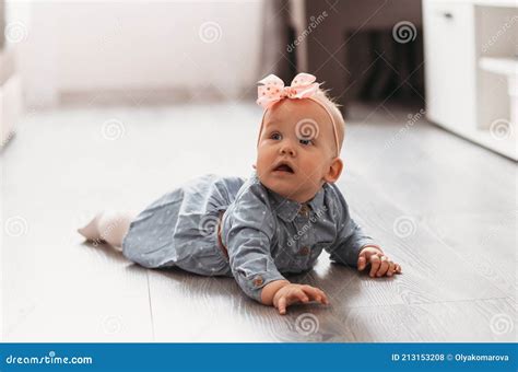 Baby Girl Learns To Crawl on the Floor in the Room Stock Photo - Image ...