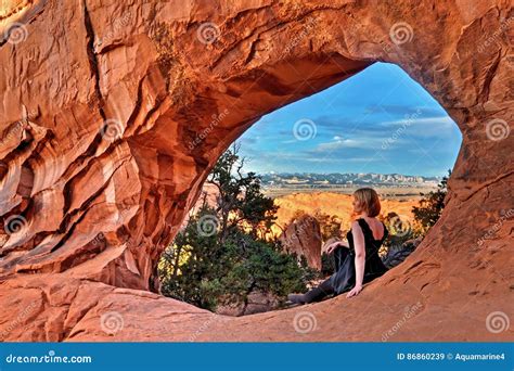 Woman by Natural Arch in Arches National Park. Stock Image - Image of ...