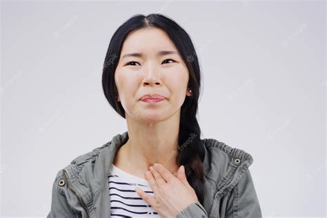 Premium Photo | Asian woman sore throat and virus in pain allergies or bacteria against a white ...