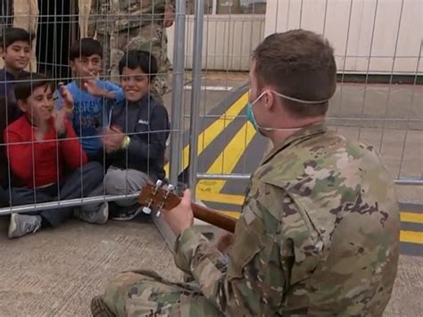 Soldier Plays Music For Young Afghan Refugees
