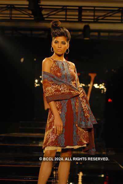 A model walks down the ramp in a dress from the latest collection from ...