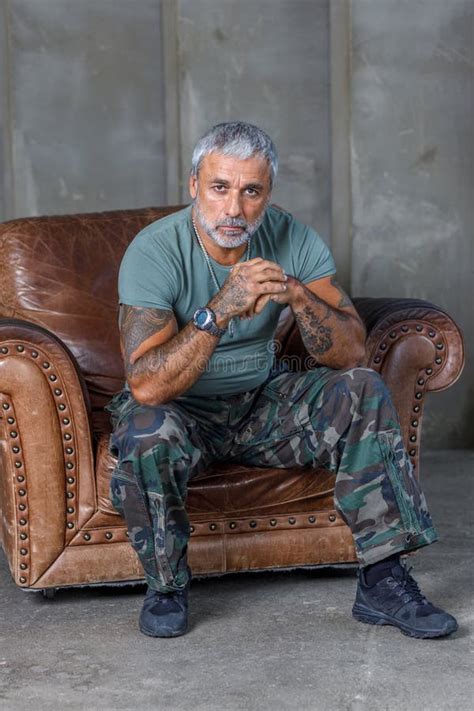 A Soldier in Camouflage, a Soldier Stands Against the Wall.a Mature ...