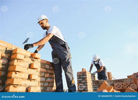 Professional Construction Workers Build a Brick House. Industrial Theme ...