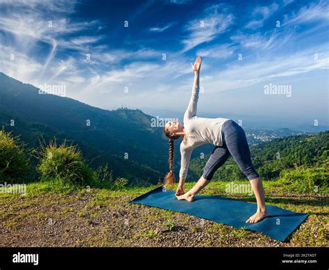 Woman doing Ashtanga Vinyasa yoga asana Utthita trikonasana Stock Photo ...