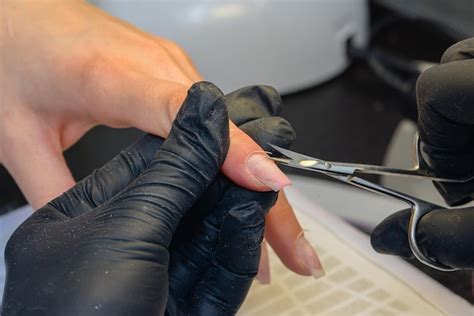 Closeup manicure process female hands painting nails | Premium Photo