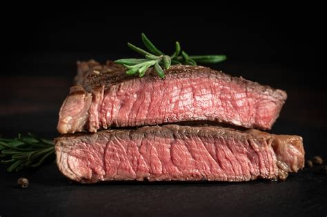 Side view of juicy roasted steak sliced in two parts made of grainfed ...