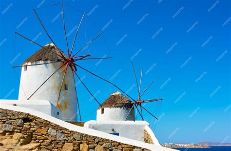 Premium Photo | Old white windmills by the sea in Mykonos island in ...