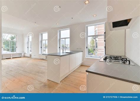 A White Kitchen with a Large Window and a Stove Stock Photo - Image of ...