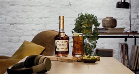 Alcoholic cocktail Hennessy Cola with lime wedge - Hennessy