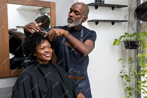 Premium Photo | Latino hair salon owner taking care of client