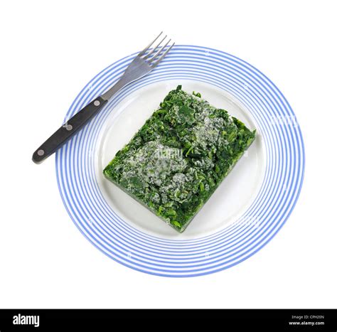 Frozen chopped spinach on plate with fork Stock Photo - Alamy