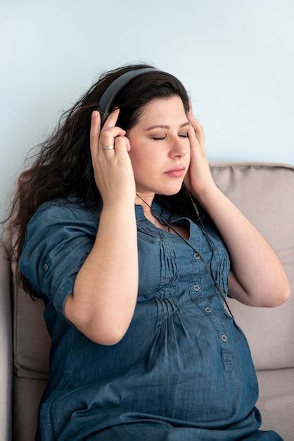 Coup moyen femme enceinte avec un casque à l'intérieur | Photo Gratuite