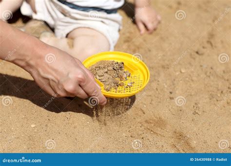Sifting sand in sandbox stock photo. Image of people - 26430988