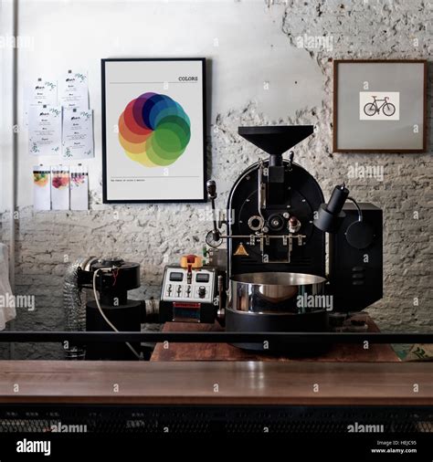 Coffee roaster with photo frames on the wall Stock Photo - Alamy