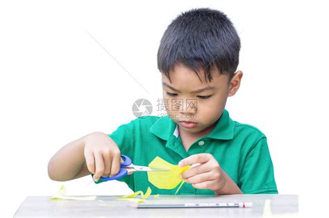 选择焦点5至6岁亚洲儿童男孩练习用木桌上的剪刀彩纸的肖像图在家学习社交距离孩高清图片下载-正版图片503945362-摄图网