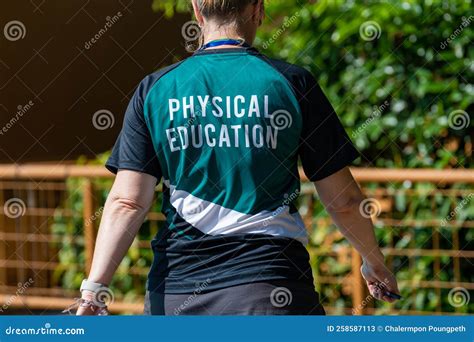 Back View of Female Swimming Coach, Wearing PHYSICAL EDUCATION Shirt ...