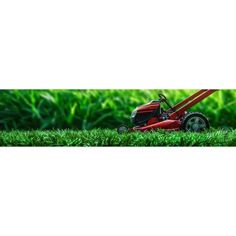 A red lawn mower is laying in the grass | Premium AI-generated image
