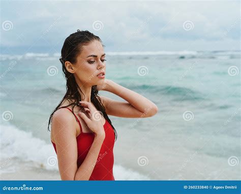 Woman with Wet Hair in Red Swimsuit on Oceanfront Sunbathing Stock ...