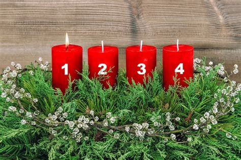 Four red burning candles. advent decoration christmas tree branches ...