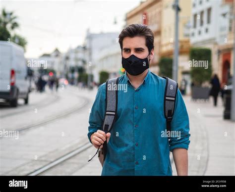 A Spanish male with face mask walking outdoors - concept of the new ...