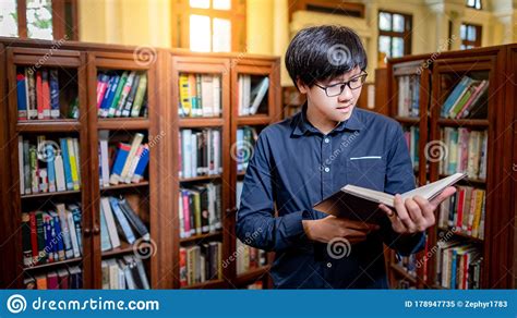 Smart Asian Man Student Reading Book In Library Stock Image - Image of ...